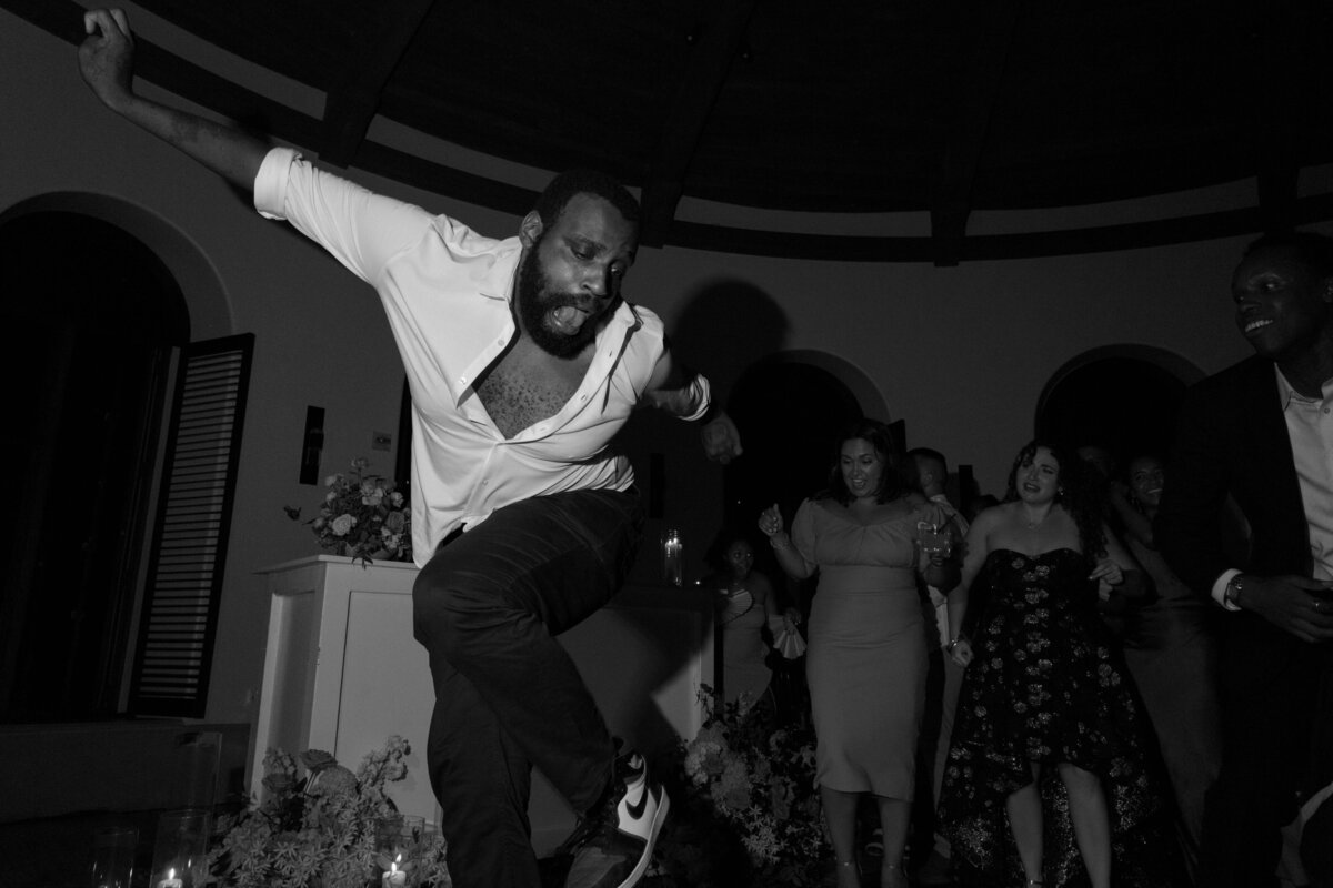 wedding guest dancing  to dj sing playing at an exclusive luxury wedding venue