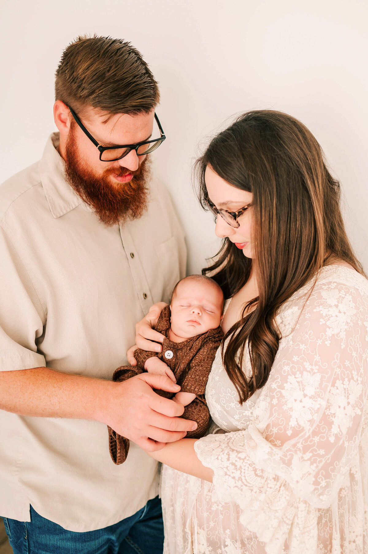 newborn photo in Branson MO of baby boy sleeping in parents arms