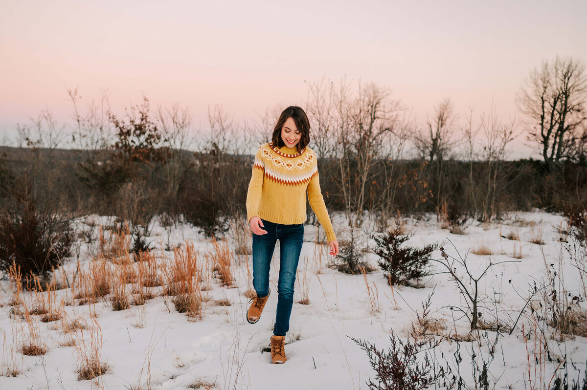 teen girl kicking the snow at Branson senior photography session