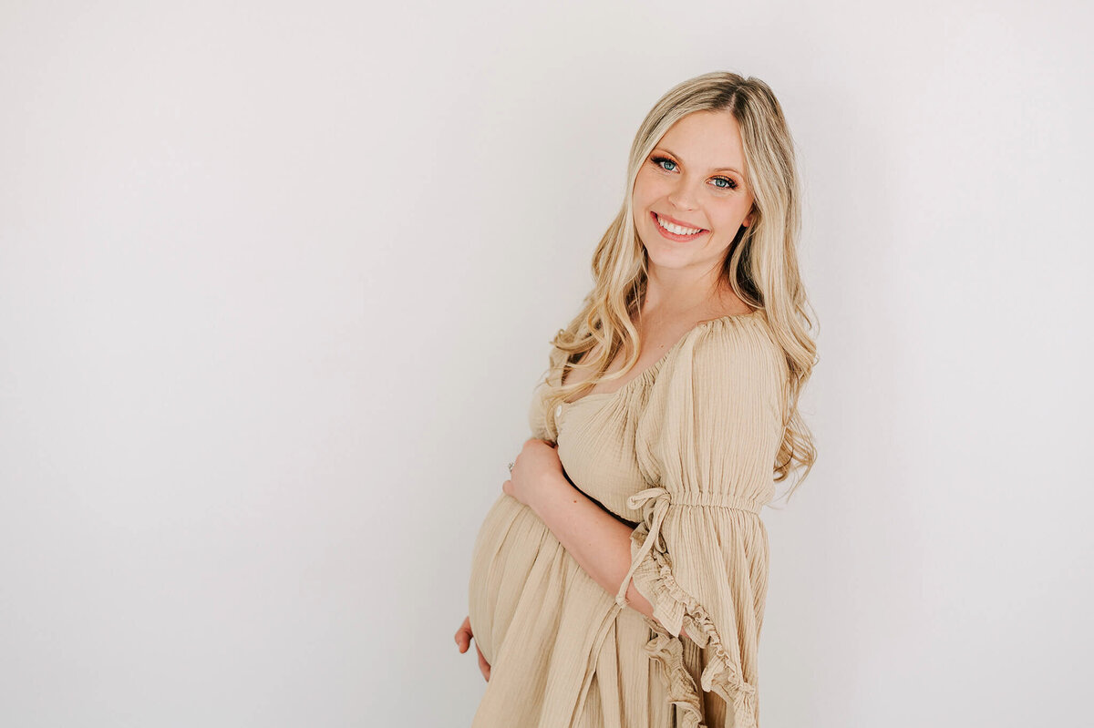 pregnant mom smiling and enjoying maternity photography in Joplin Missouri