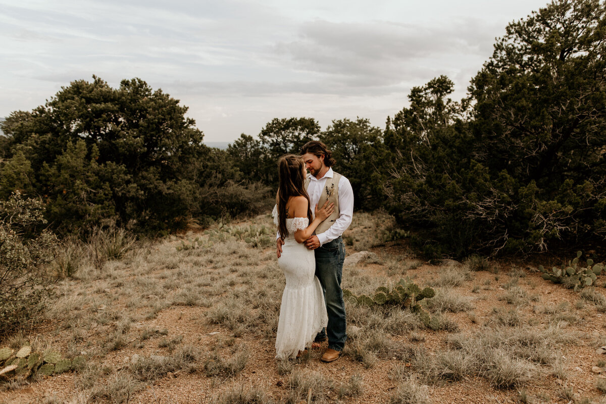 Bride and groom holding each other at the foothills in Albuquerque New Mexico
