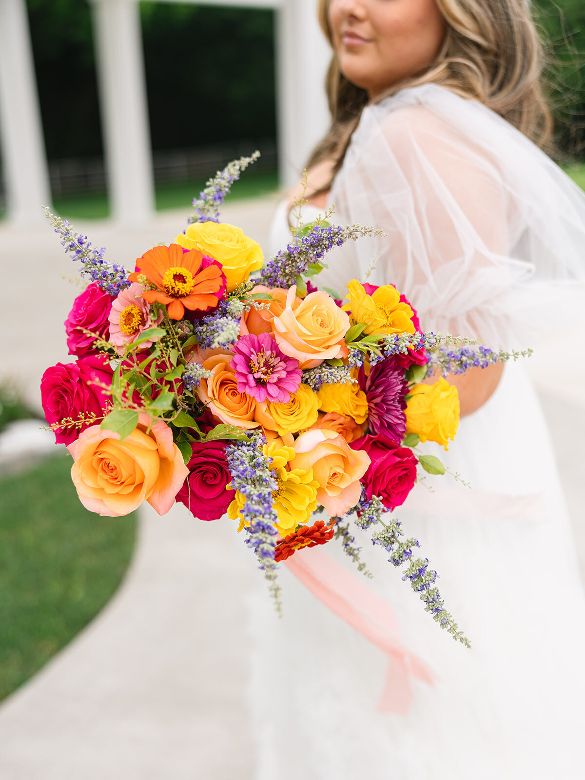 Vibrant bridal bouquet featuring coral dahlias and garden roses by Kendra’s Events in Fort Worth, TX.