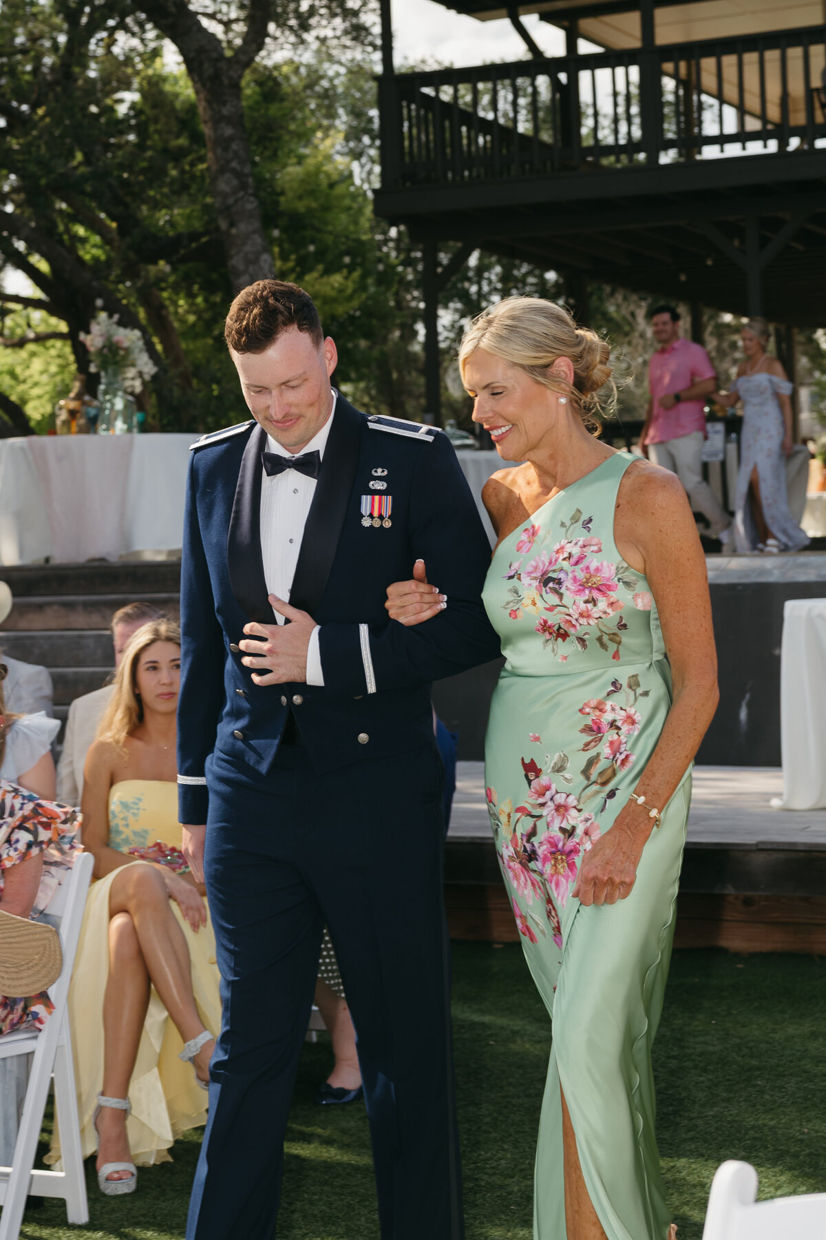 Groom and grooms mom walking down the aisle