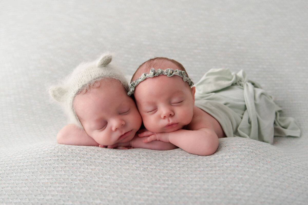 twin newborn boy and girl on a mint green drop for their twin newborn photography session in Burlington, Ontario.