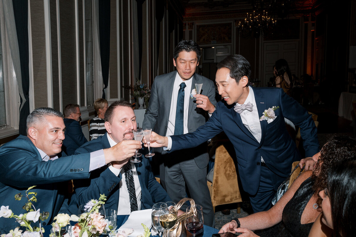 Couple greeting wedding guests Beacon Grand San Francisco Bay Area hotel wedding photographer