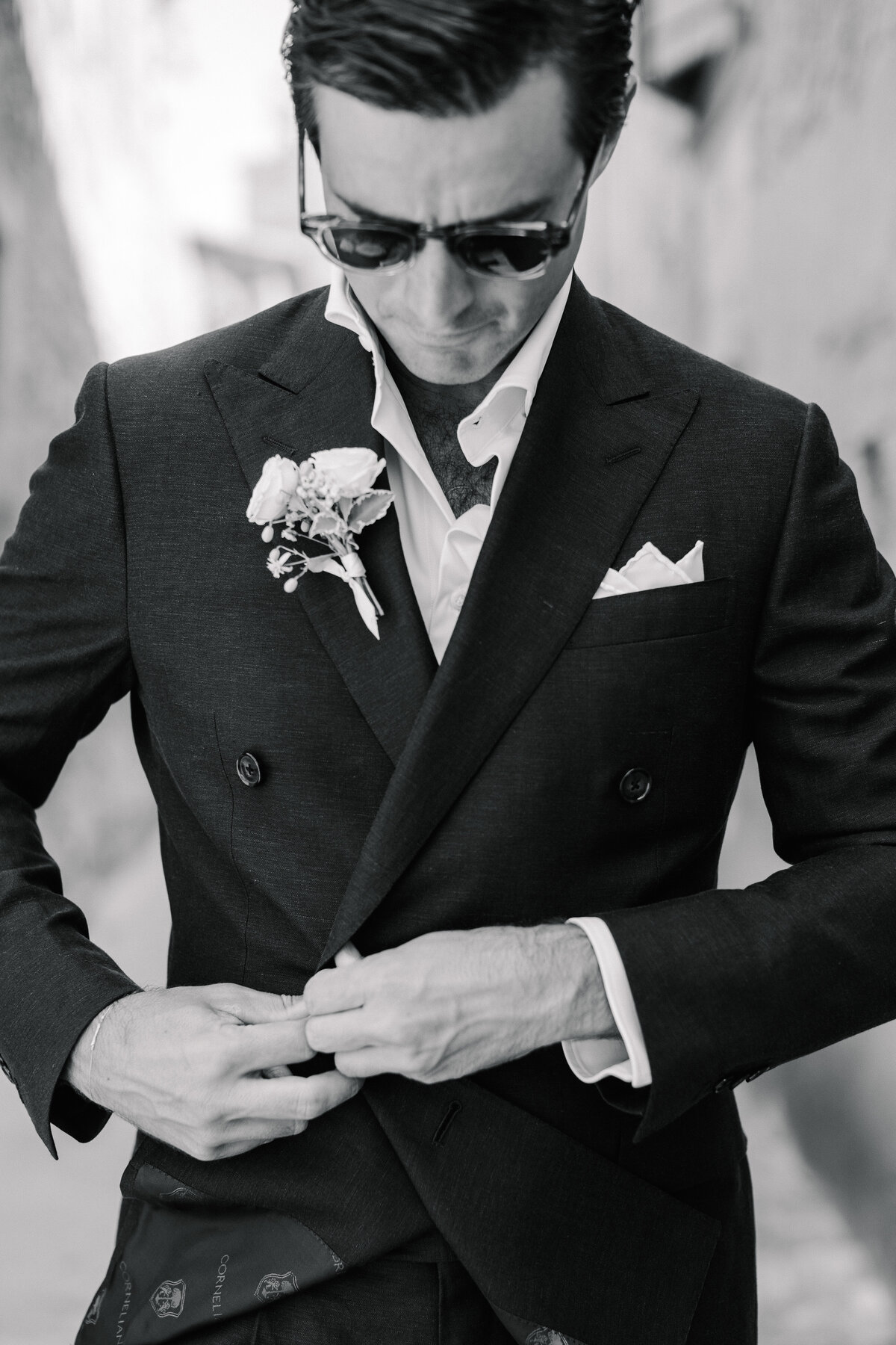 groom getting ready in corneliani suit for wedding in menerbes france