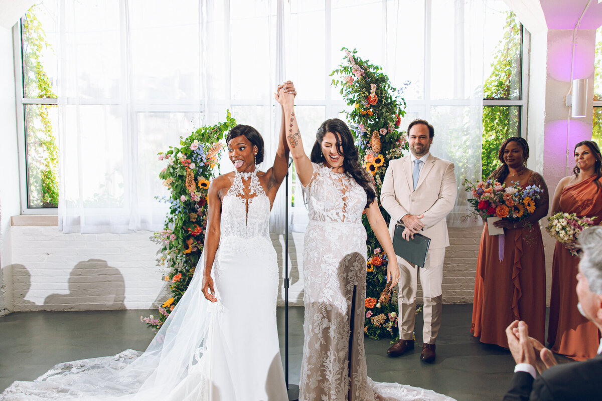 A queer couple celebrates during their wedding ceremony at Room 1520 in Chicago