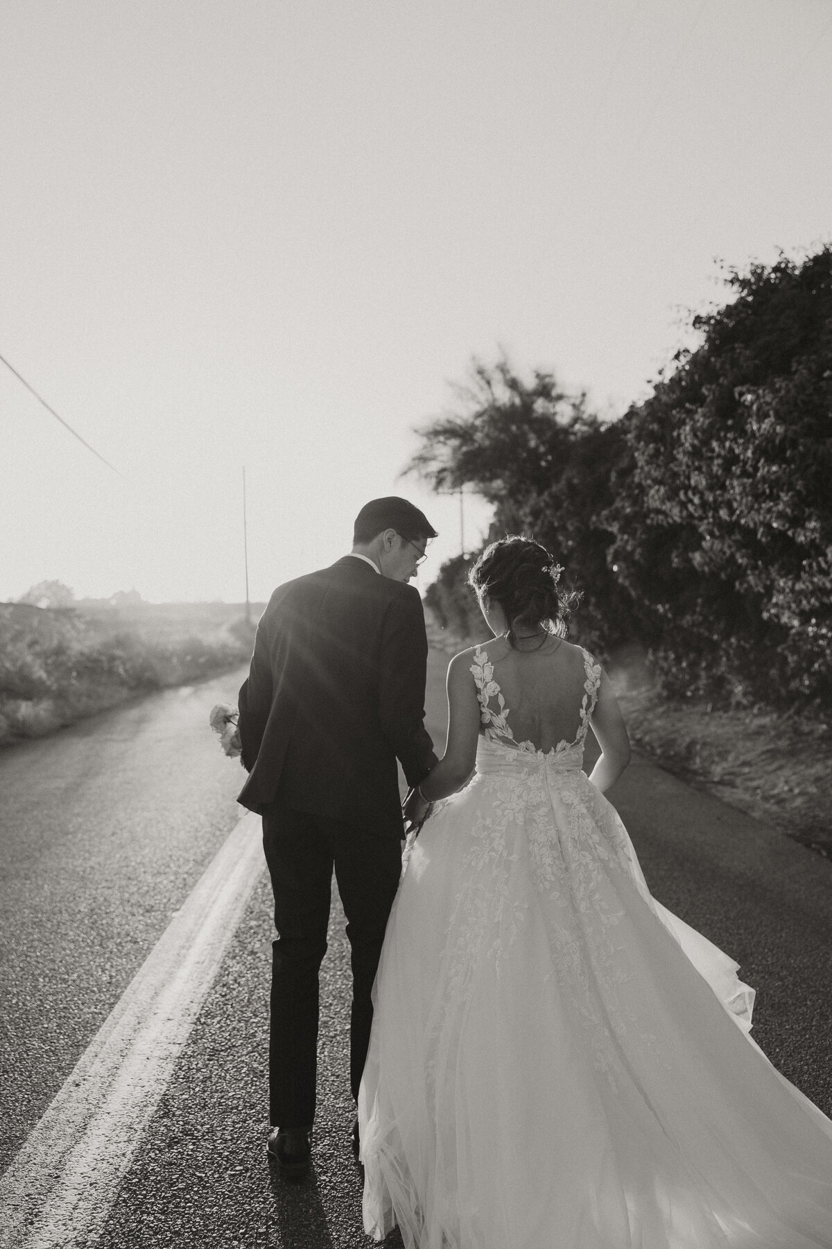 bride and groom running away on road, botanica wedding