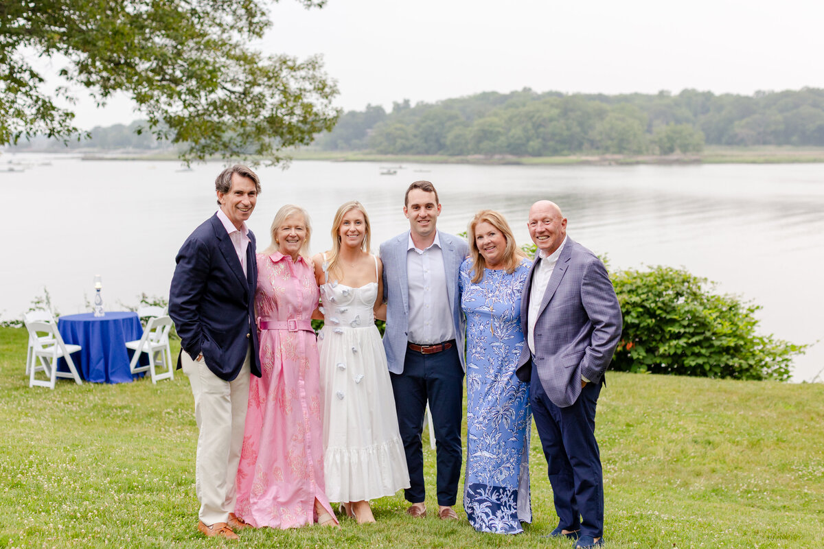 bride and groom with parents at rehearsal dinner