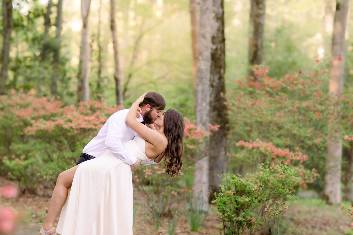 Man dipping his woman for a kiss in the forest at Callaway Gardens.