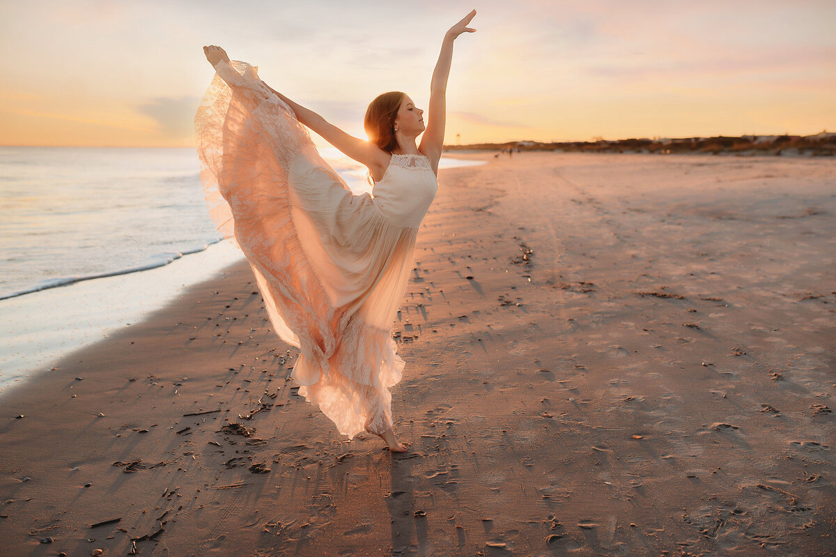Little girl dances on the beach during Family Portraits in Isle of Palms.