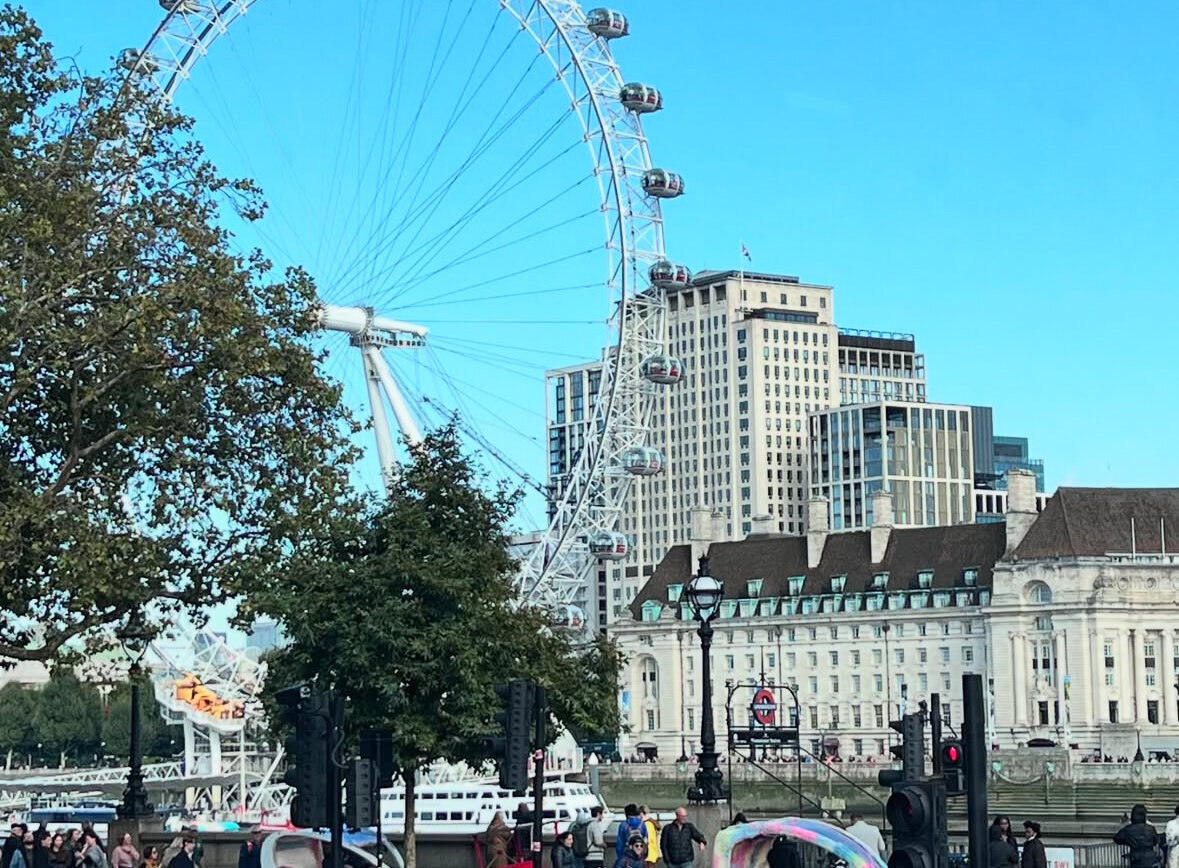 London Eye in London, England with City Buildings