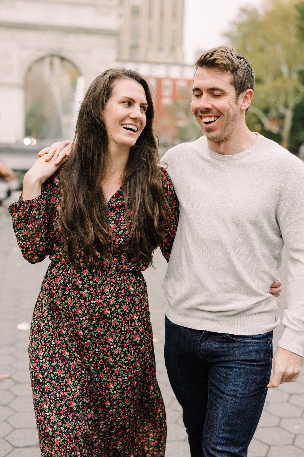 A couple taking a morning stroll through Washington Square Park in the West Village of NYC