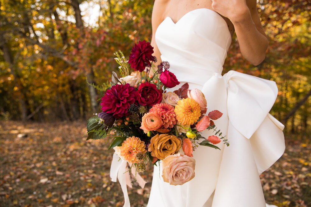 beautiful red and orange bridal bouquet by petal and fern wnc