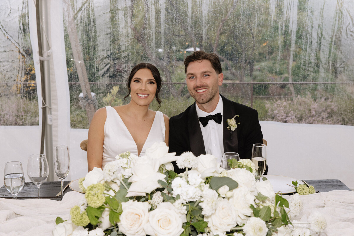 Tent wedding, bow tie, wedding gown, sage green, white flowers, roses, snowballs