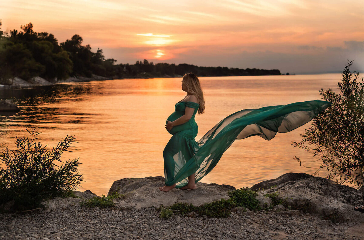 Pregnant mom posing on a beach during sunset time near the Greater Toronto area by Maternity Photographer, Tamara Danielle.