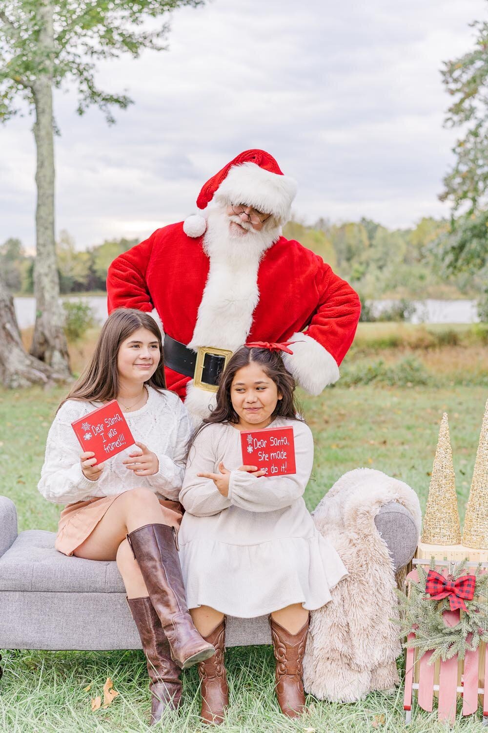 siblings holding a Santa sign during their Santa mini session in Ashburn, Virginia