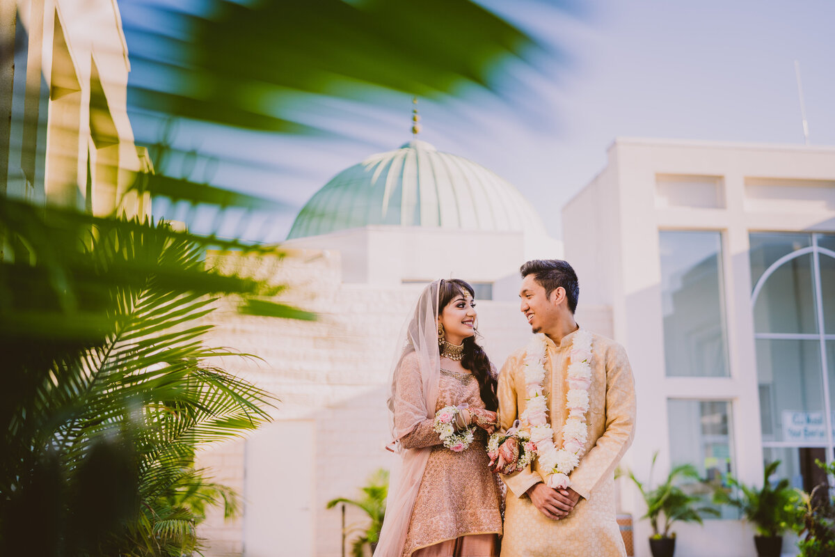 muslim bride and groom share moment outside the islamic center of long island mosque in westbury after the nikkah wedding ceremony
