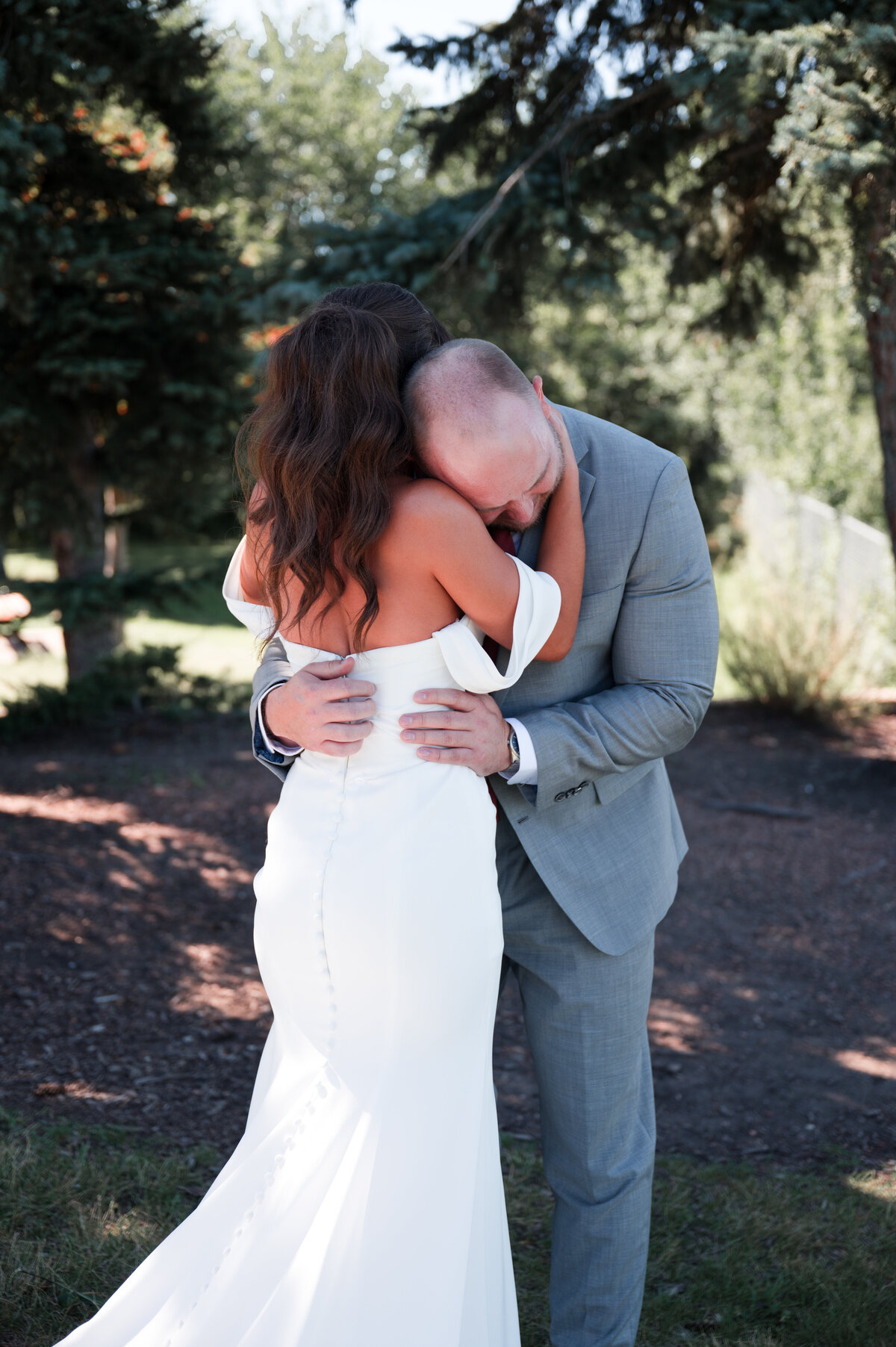 groom hugging bride after first look