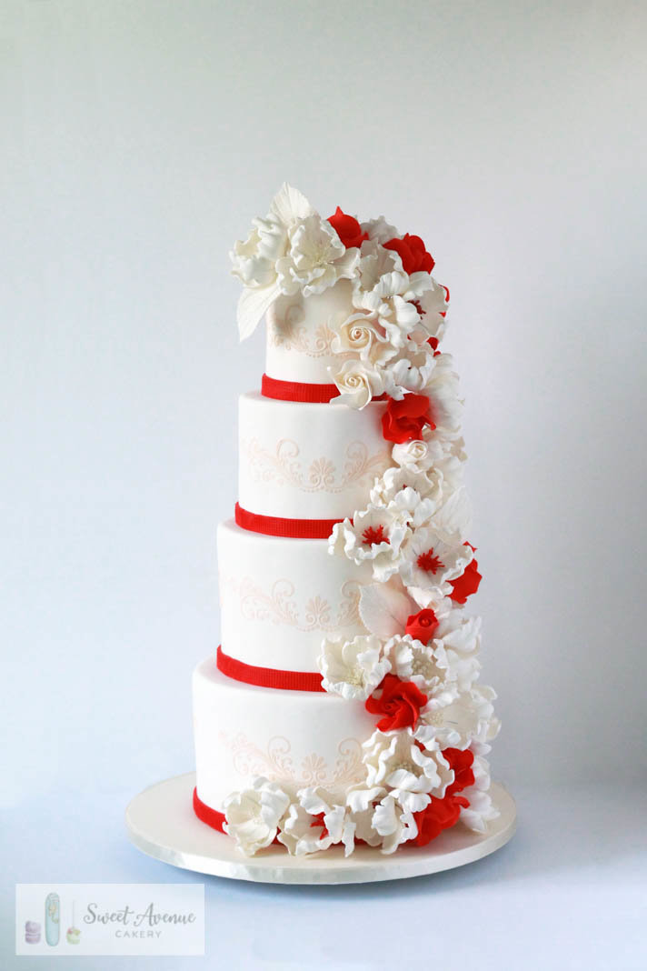 four tier white and red wedding cake with stencil lace and floral cascade, wedding cakes Hamilton ON