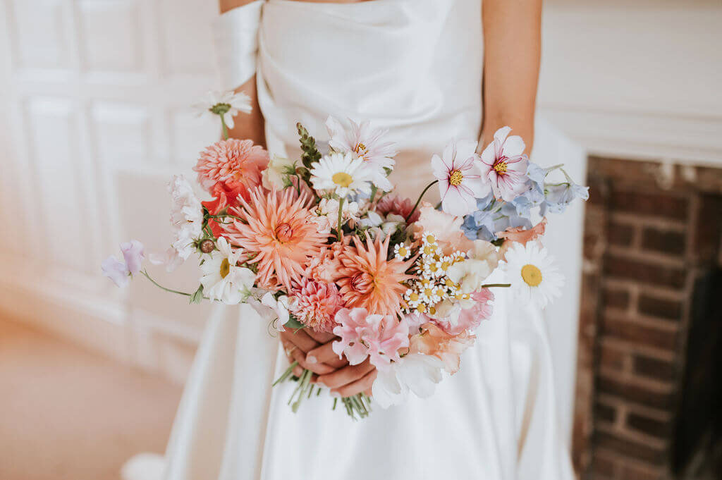 BRIDE CARRYING FLOWERS BROADFIELD COURT