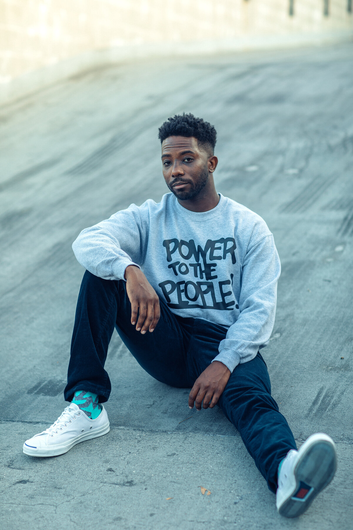 Portrait Photo Of Young Black Man Sitting On a Cement Floor Los Angeles