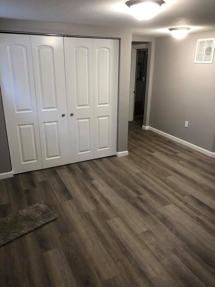 Remodeled room with grey walls and dark grey floors