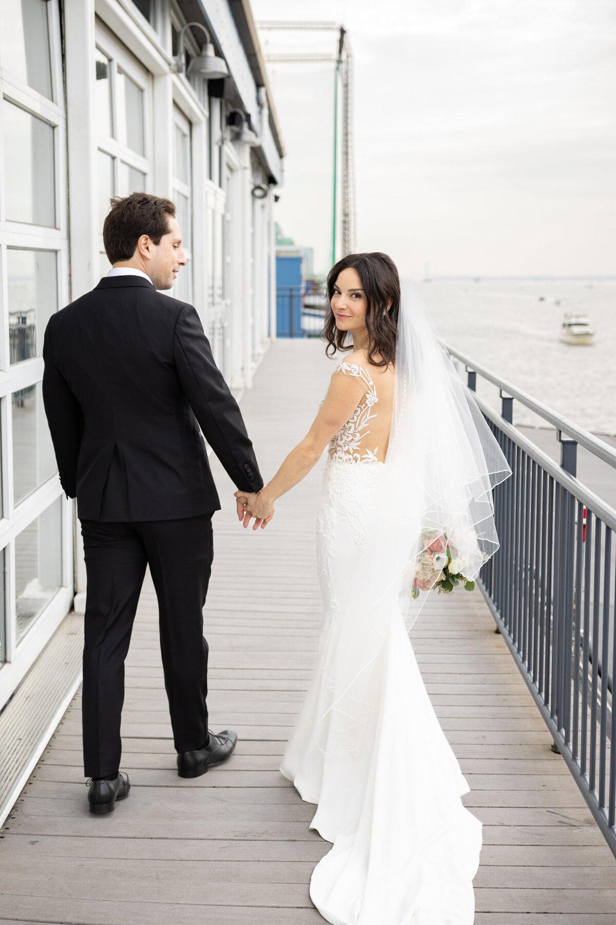 the bride loks over her shoulder as she walks away