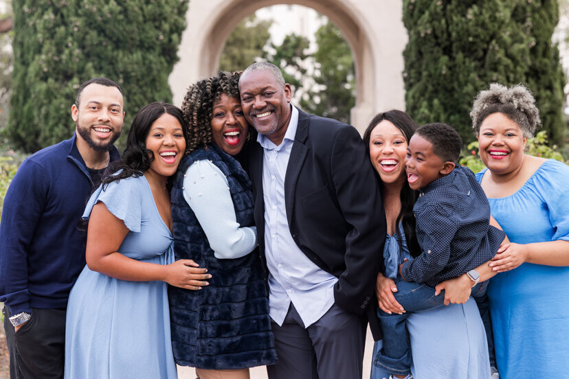 family hugging and laughing at balboa park