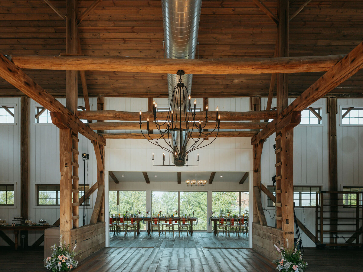 color image of the interior of the Willowbrook wedding venue with 100 year old beams and white shiplap walls winery style