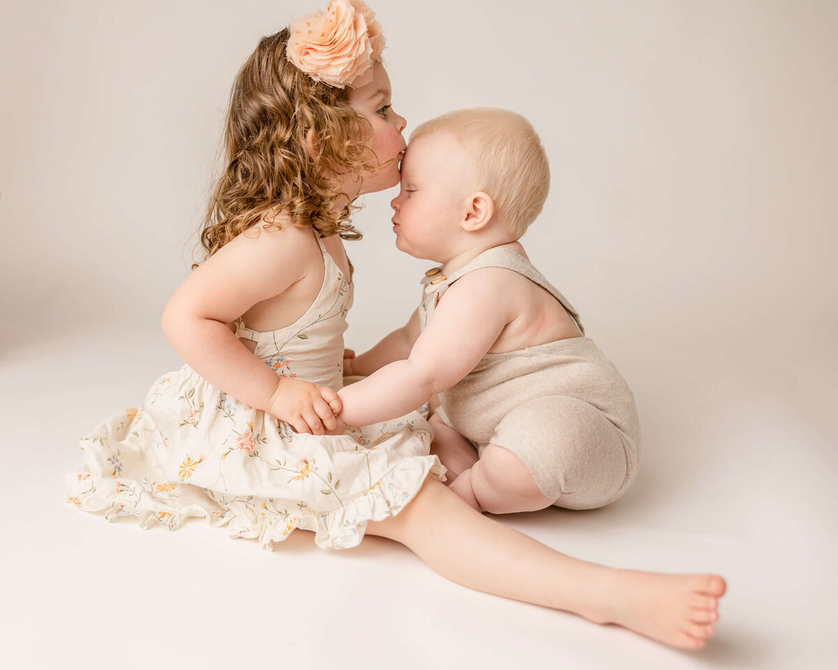brother and sister kissing in milestone pictures in portland studio