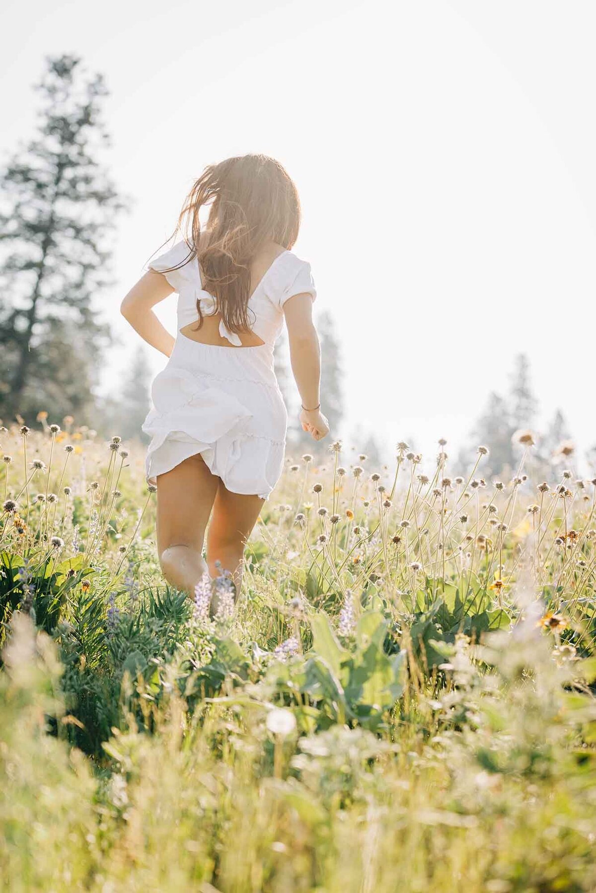 Senior picture of girl running at North Loop Trail, Missoula