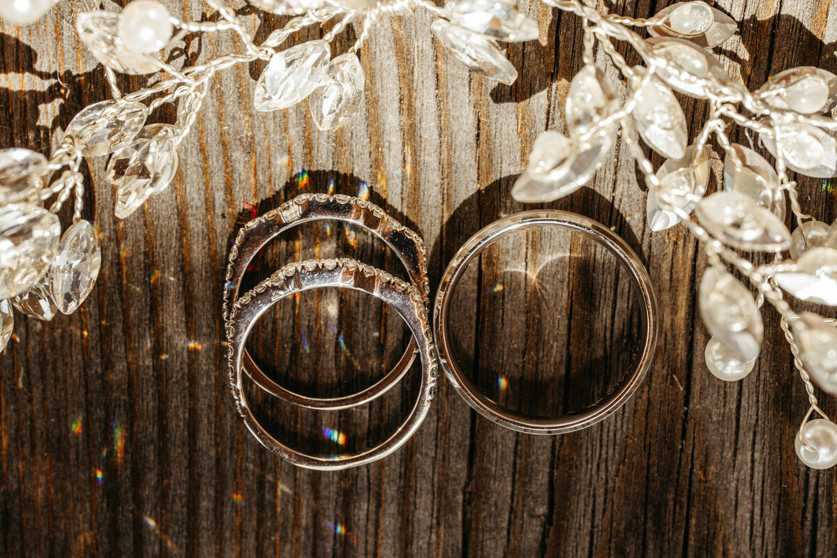 Engagement and wedding rings in wooden box with daisies