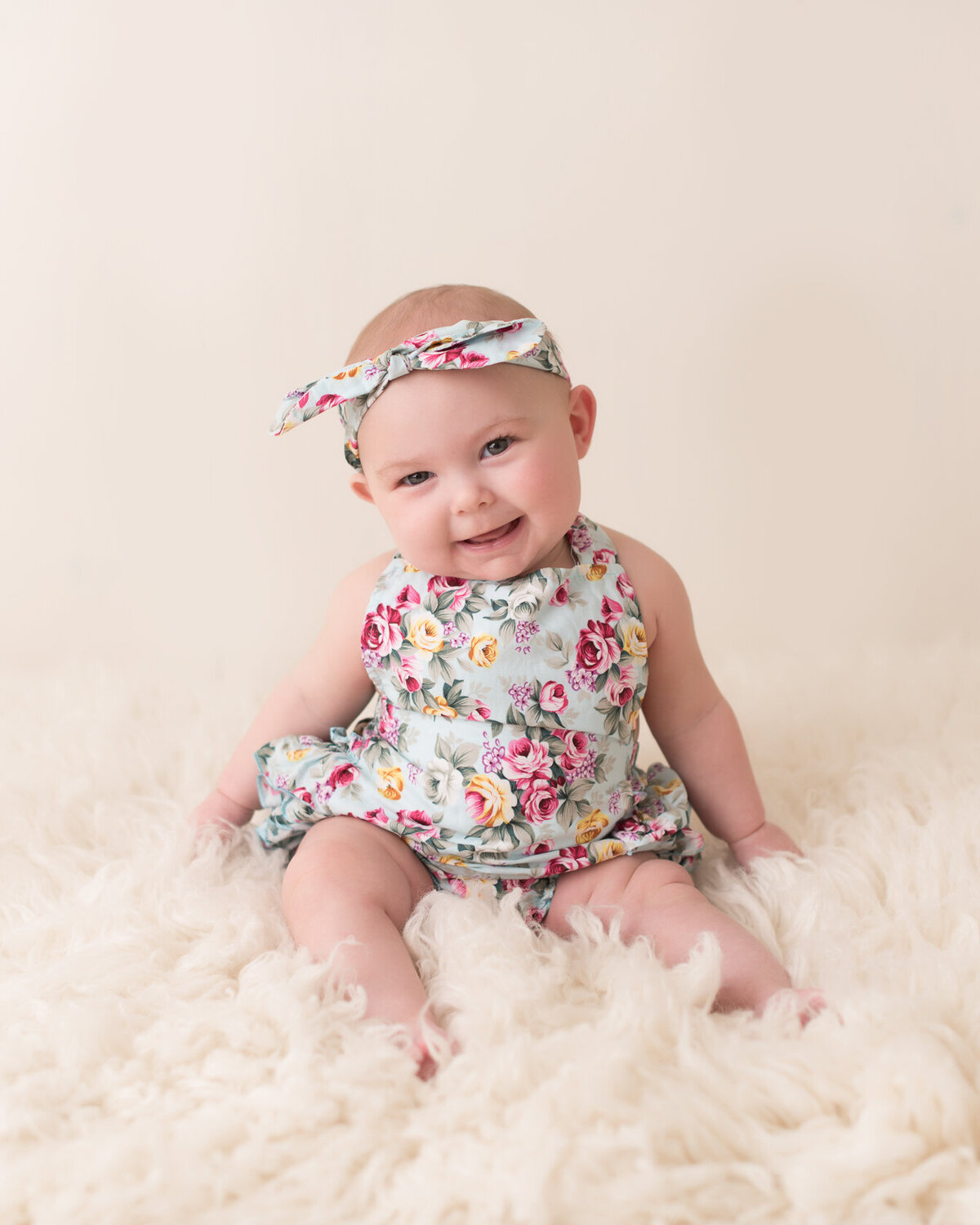 Adorable baby in cream furry background portrait
