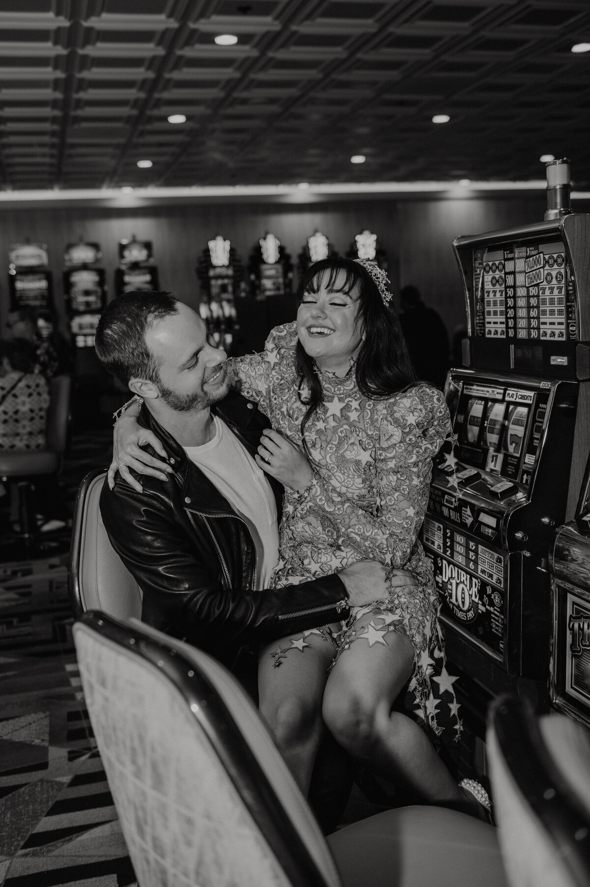a bride and groom hit the streets of las vegas nevada on fremont street experience with their elopement photographer in a casino