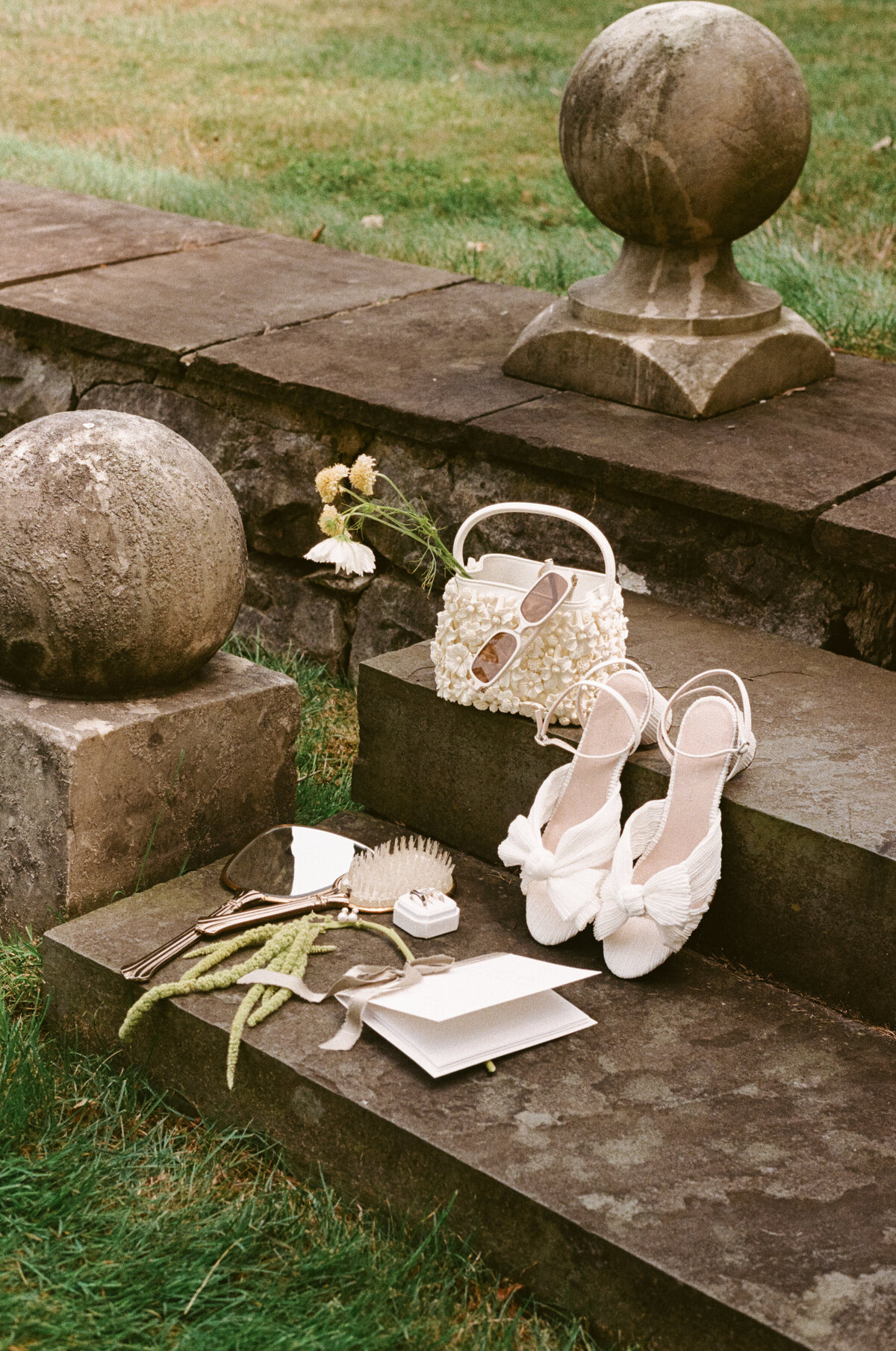 Striking fashion forward bride portrait captured in dramatic architectural lighting by NYC editorial wedding photographer Lauren Alatriste. This luxury destination wedding image showcases the bride's elegant silhouette against the rustic sophistication of Lion Rock Farm's historic stone architecture, embodying the perfect blend of editorial artistry and authentic emotion.