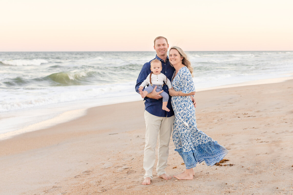 Family of three pose for a family session in Ponte Vedra