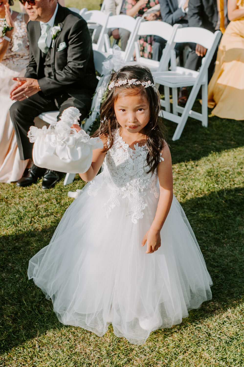 Cute flower girl in her white dress