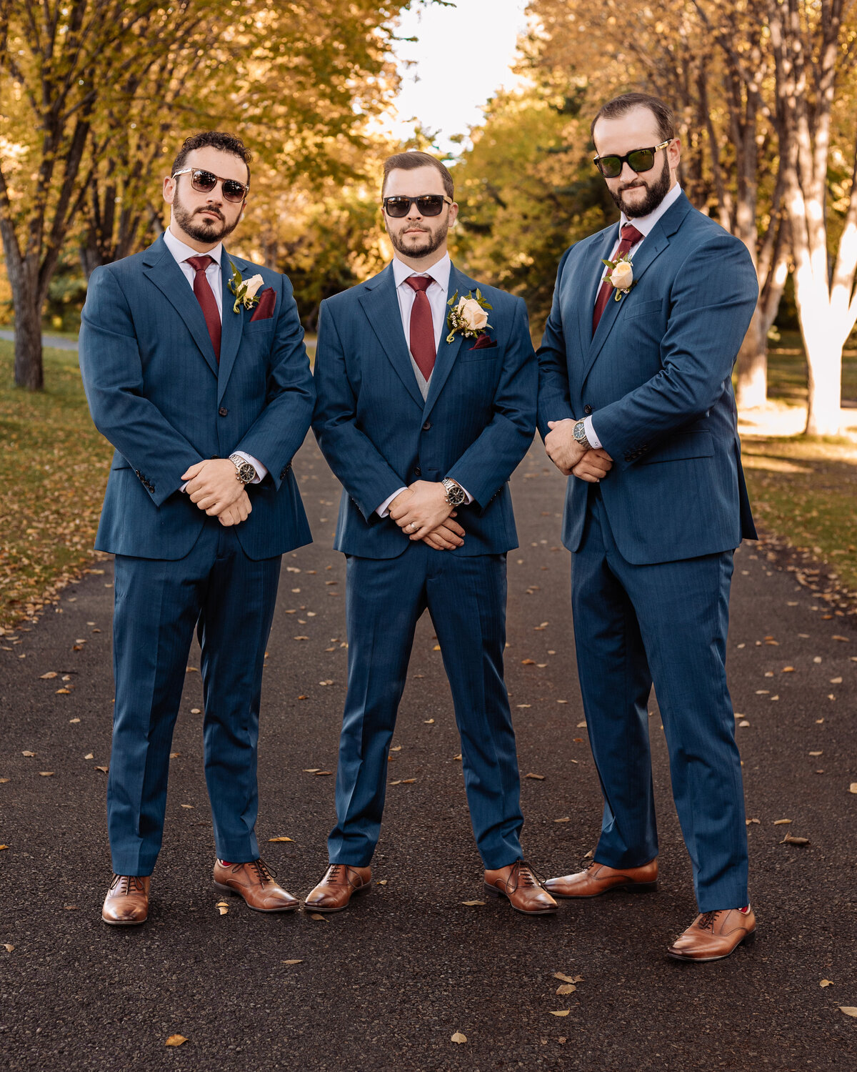 Groomsmen posing with sunglasses on at Baker Park