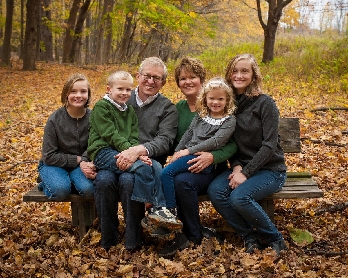 Fall family portrait of extended family grandparents with 4 grandchildren kids