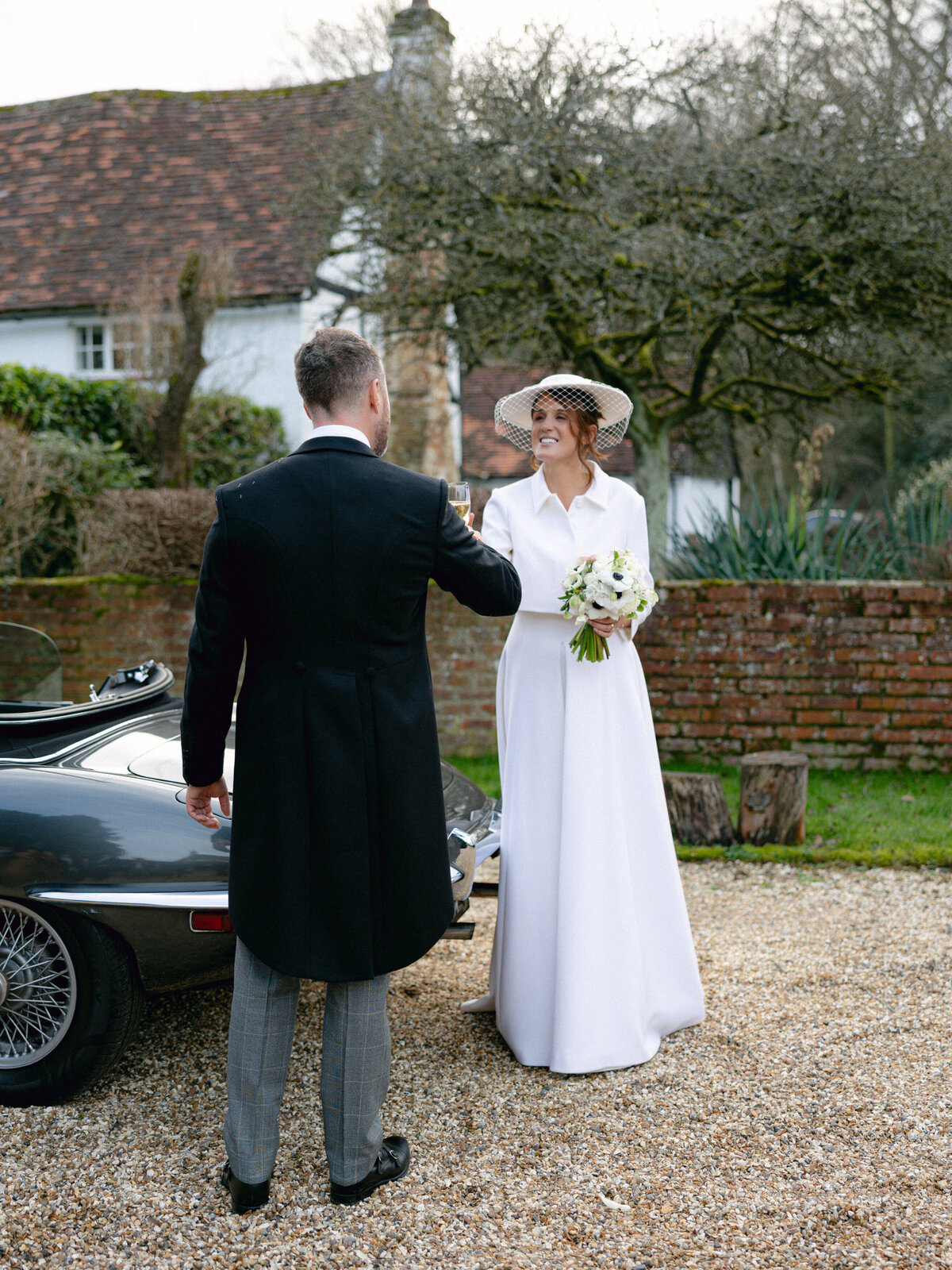 Bride wearing hat and groom