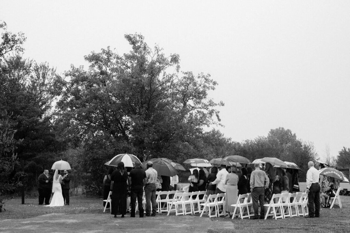 guests-watch-ceremony-outside-in-the-rain