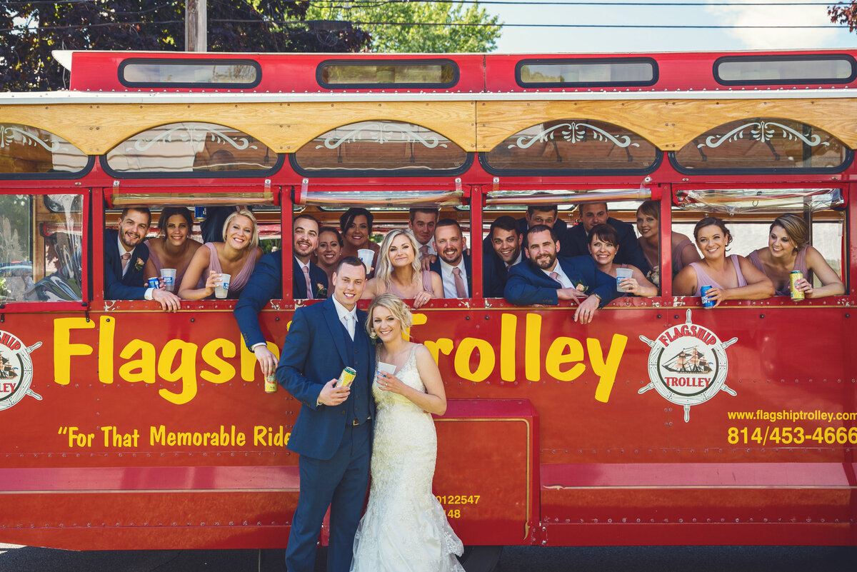 Bridal party celebrating on a wedding trolley.