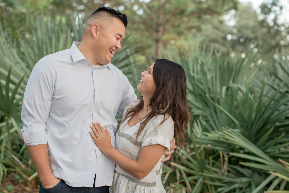 An engaged couple laughs together during their engagement photography session. Captured by Boulder photographer Stephanie Eddy