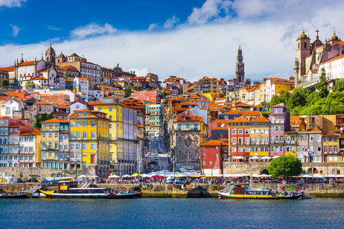 Waterstone - Travelive - Portugal - Luxury Destination Management Company - Porto, Portugal old town skyline from across the Douro River.