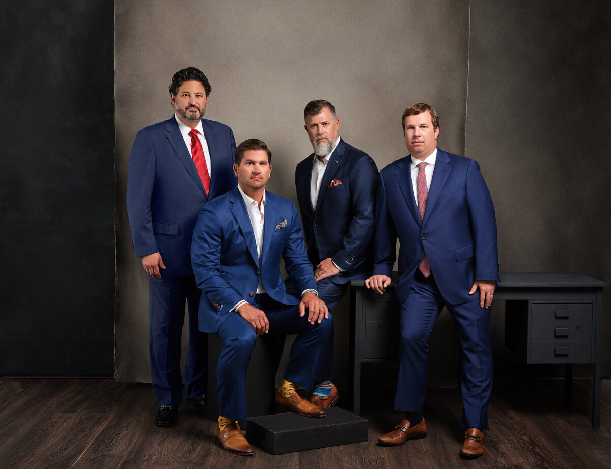 A group of men in suits smiling