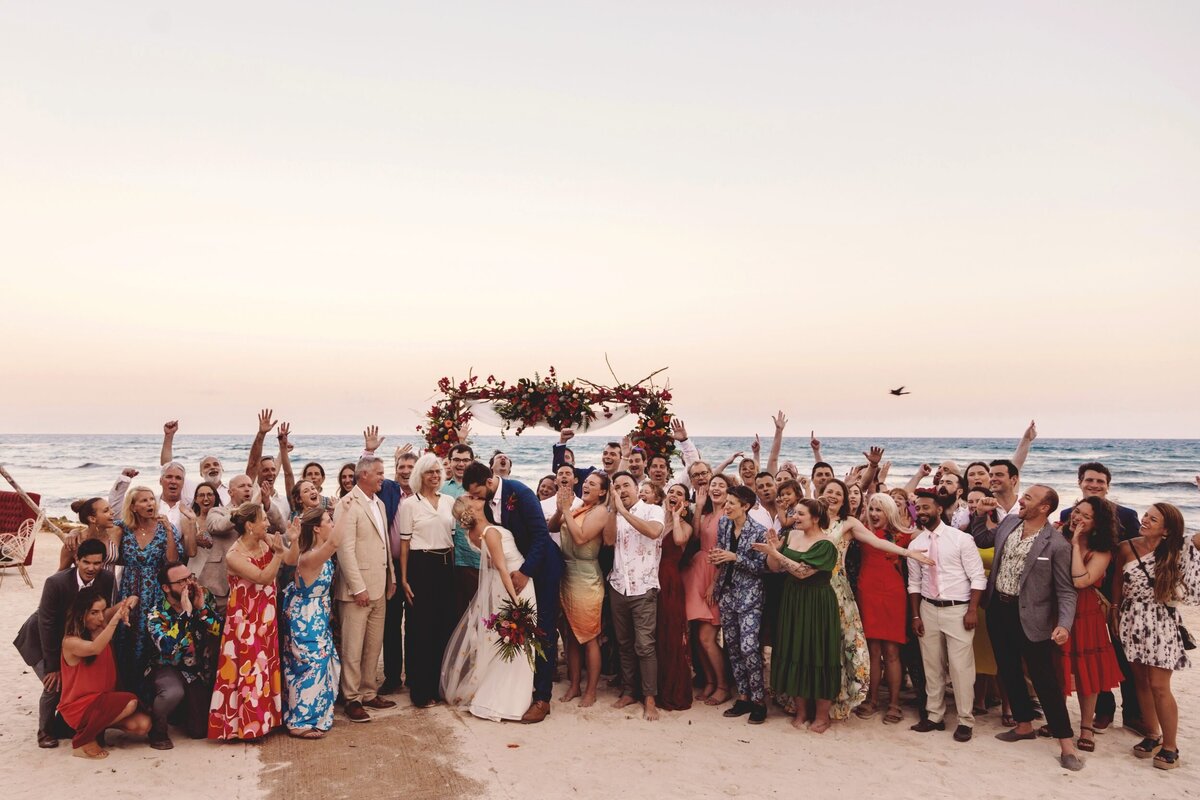 Bride and groom with all guests at wedding in Blue Venado Seaside Riviera Maya