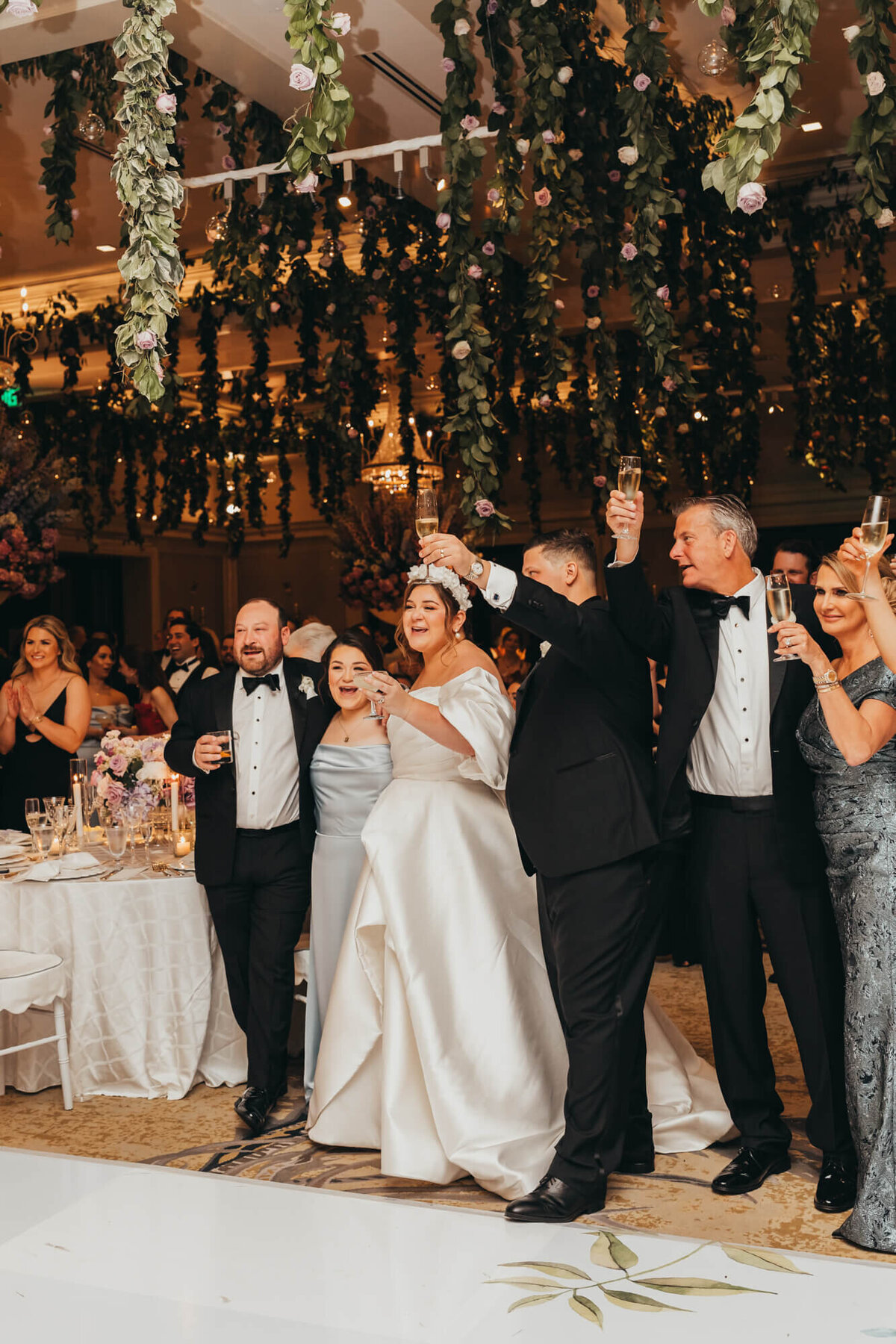 bride and groom raise their glass to a toast about their special day, from brides dad.