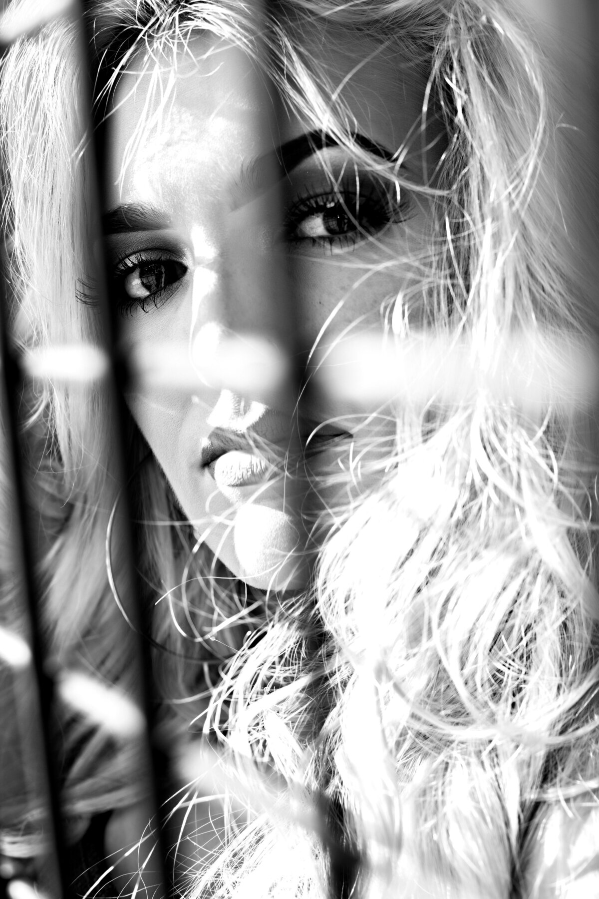 Woman looking through a fence
