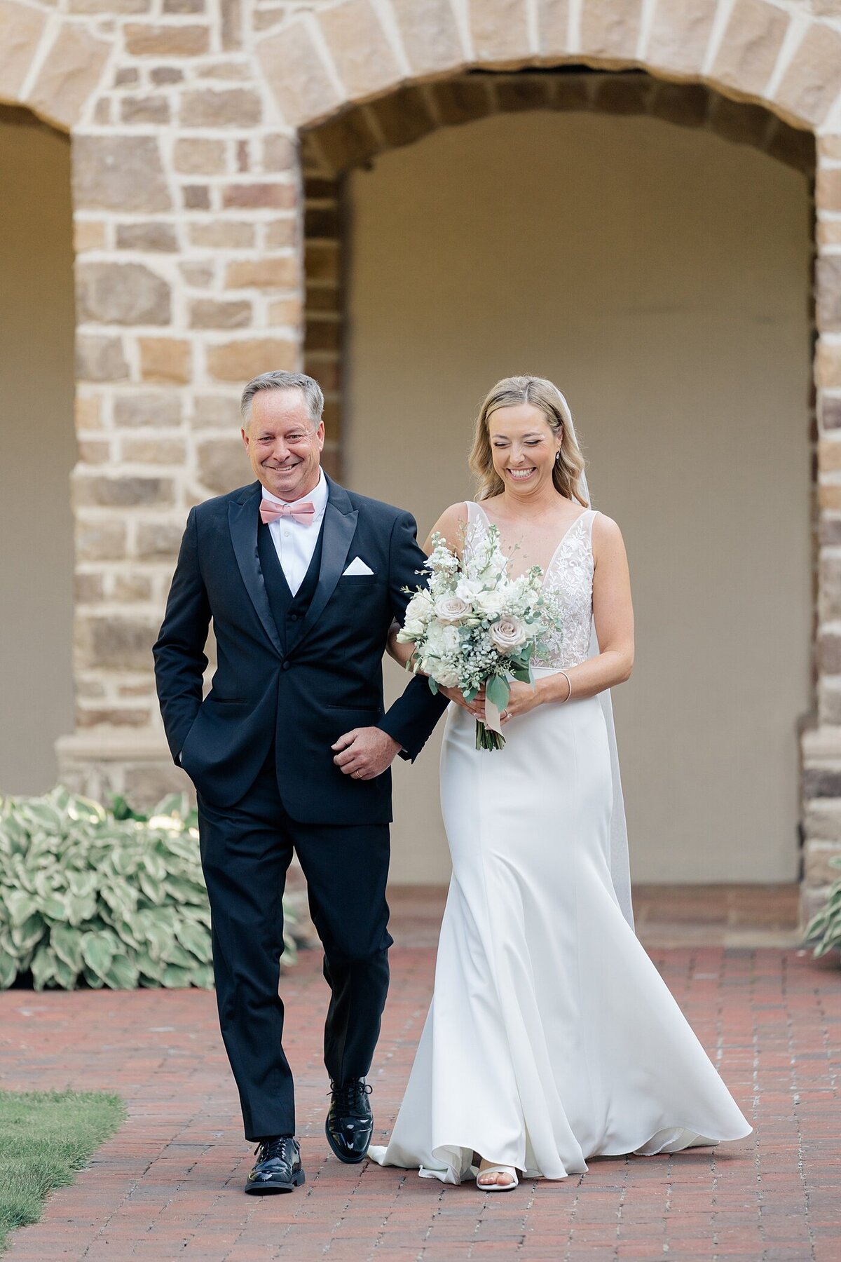 father of the bride walks his daughter down the aisle at the Pinnacle gold club